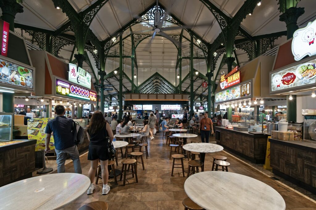 Interior of a Singapore hawker centre with diners enjoying affordable local food