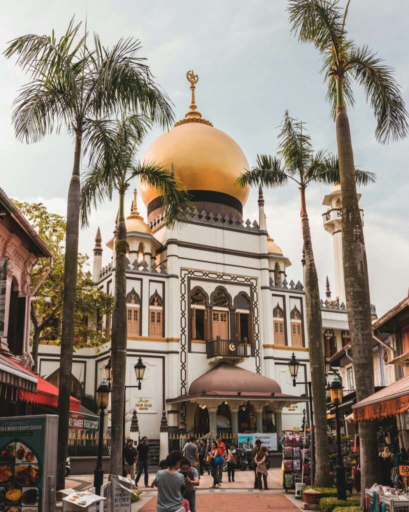 Golden dome of Sultan Mosque framed by palm trees on Muscat Street, Kampong Glam, Singapore
